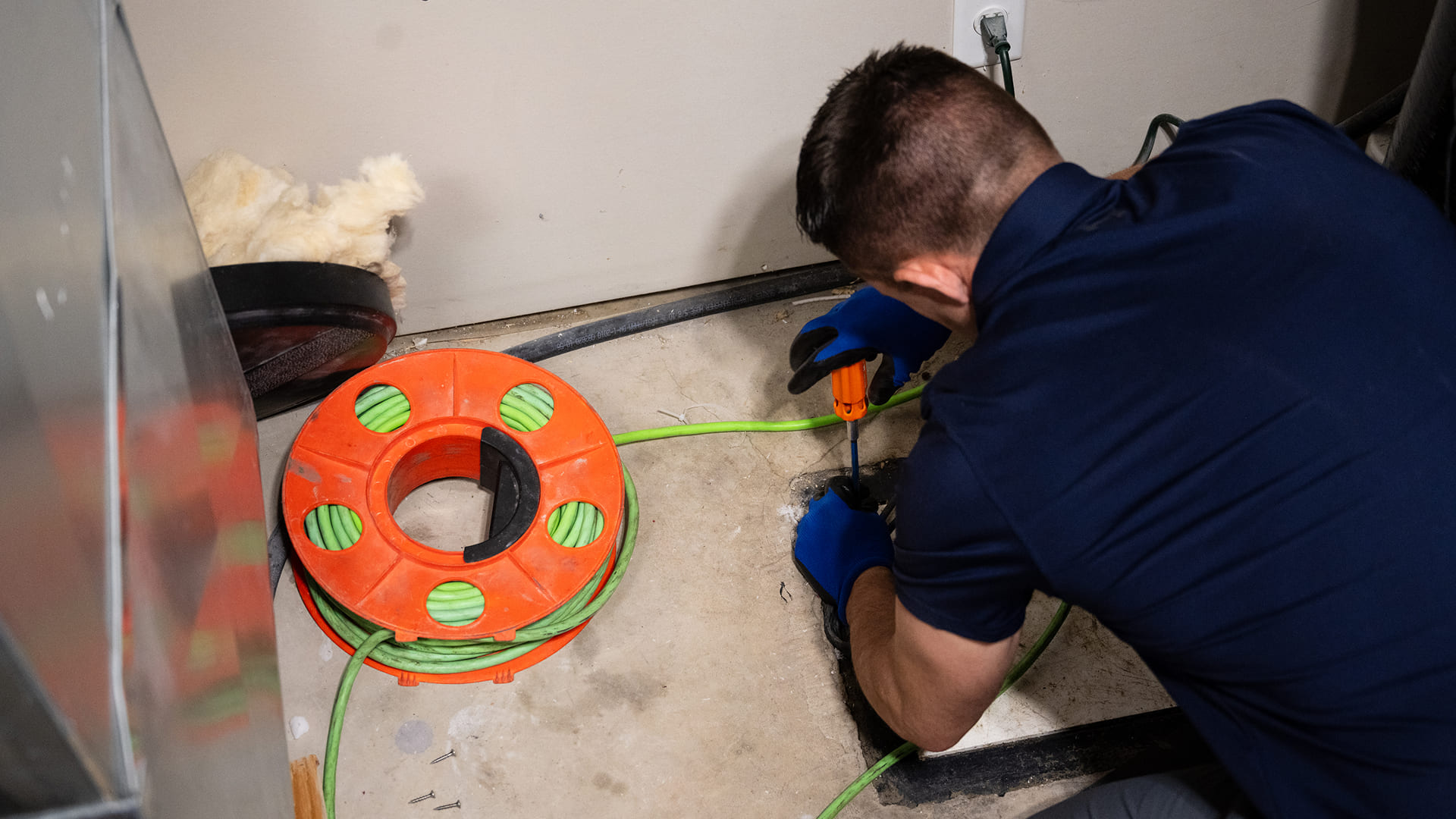 Plumber-Working-On-Floor-Drain-With-Screwdriver
