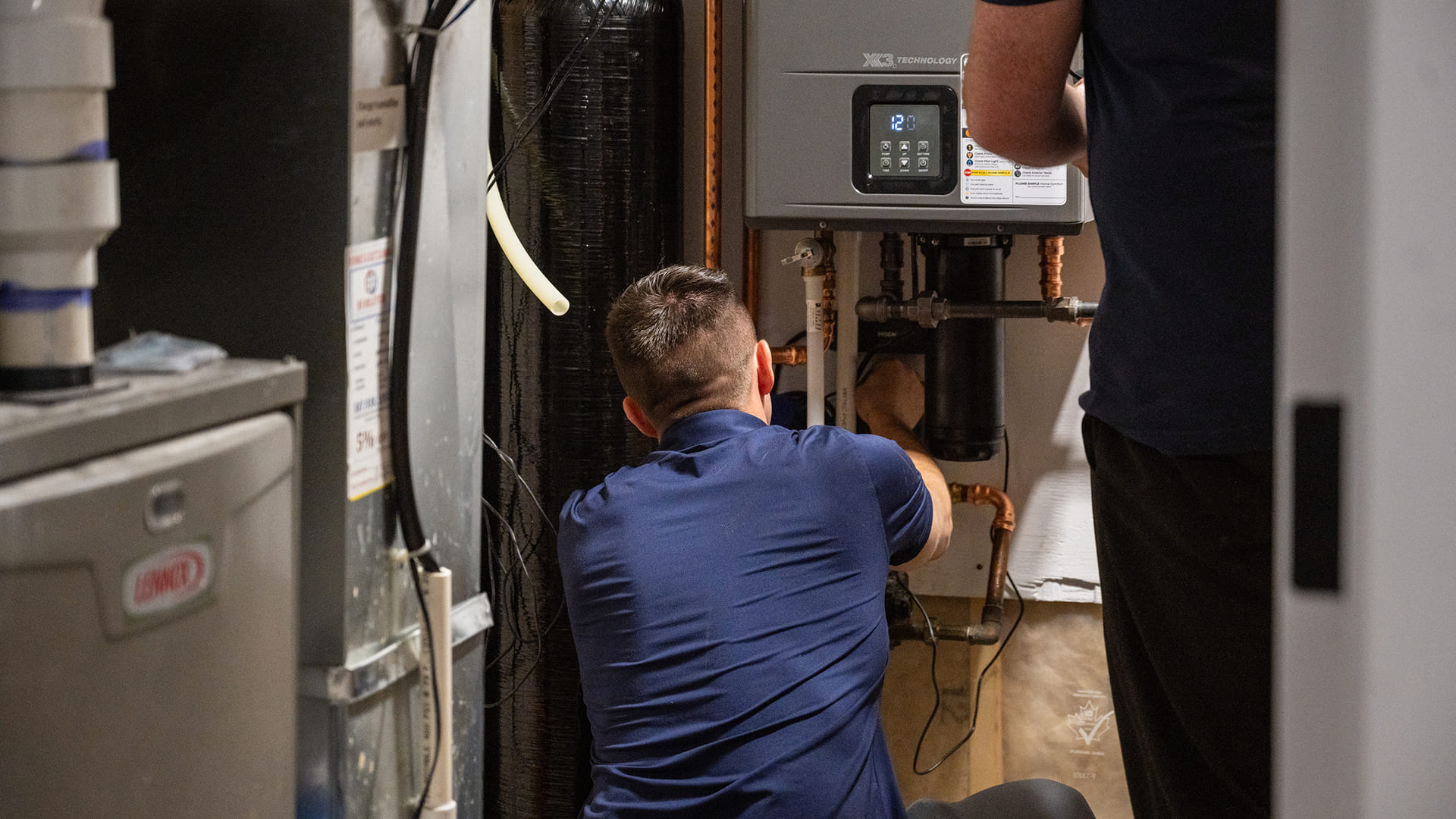 Technicians-Installing-Tankless-Water-Heater-In-Utility-Room
