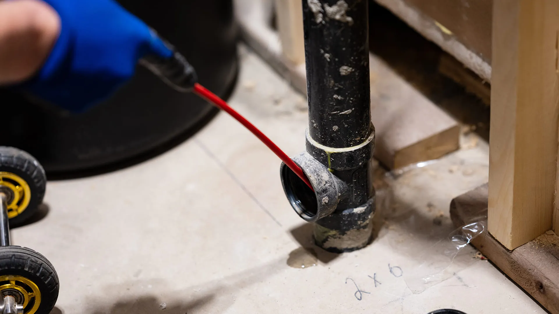 technician inserting inspection tool into drain pipe