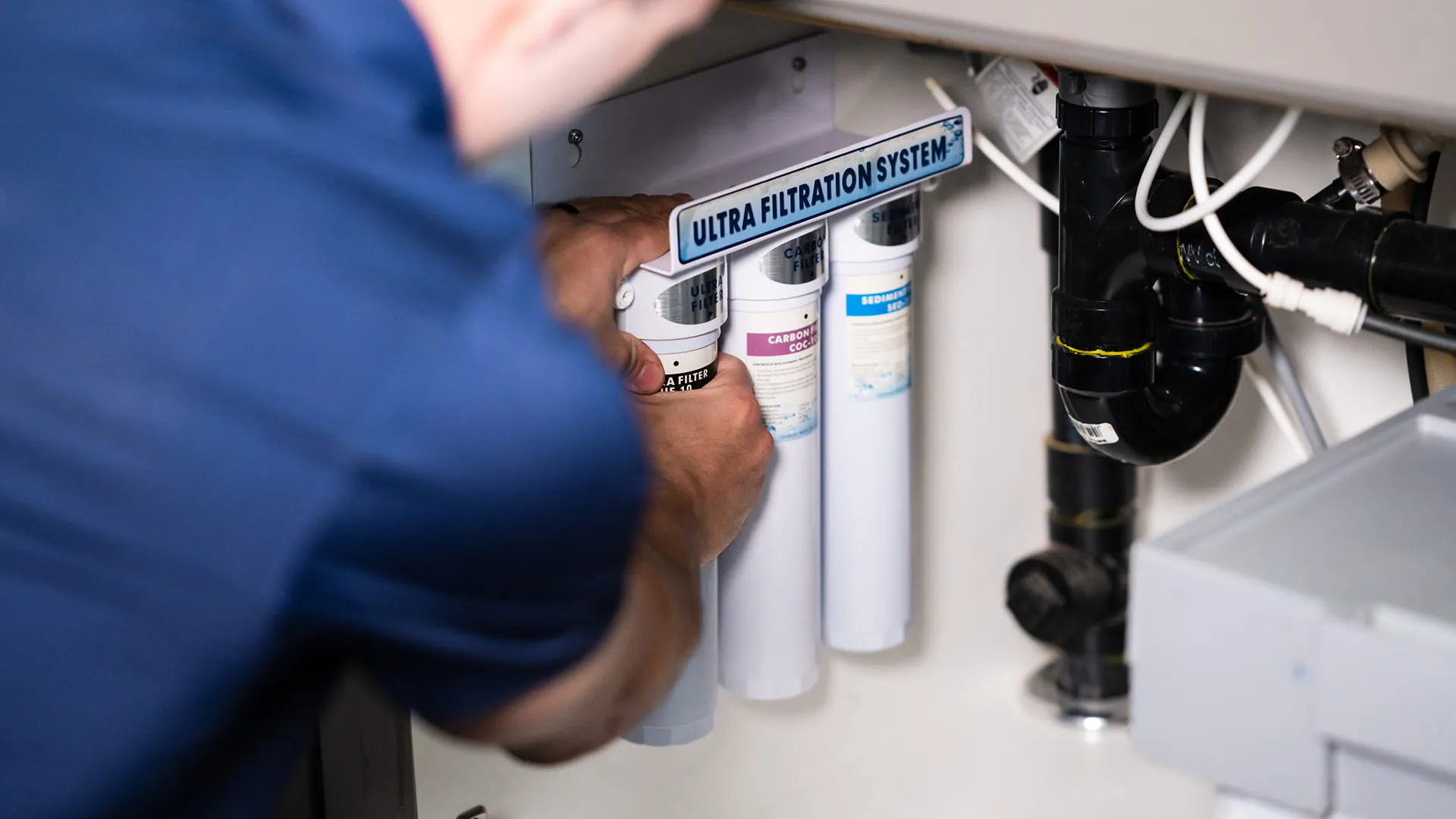 Technician-Replacing-Water-Filter-Cartridge-Under-Sink