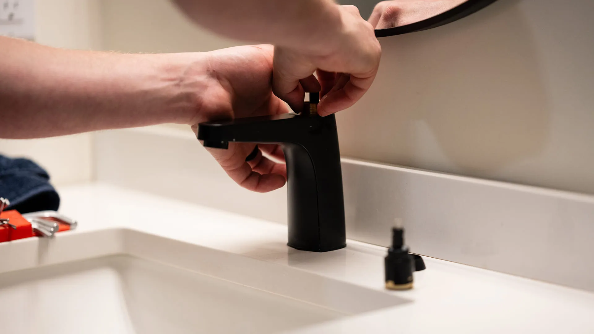 Close-Up-Of-Plumber-Repairing-Black-Bathroom-Faucet