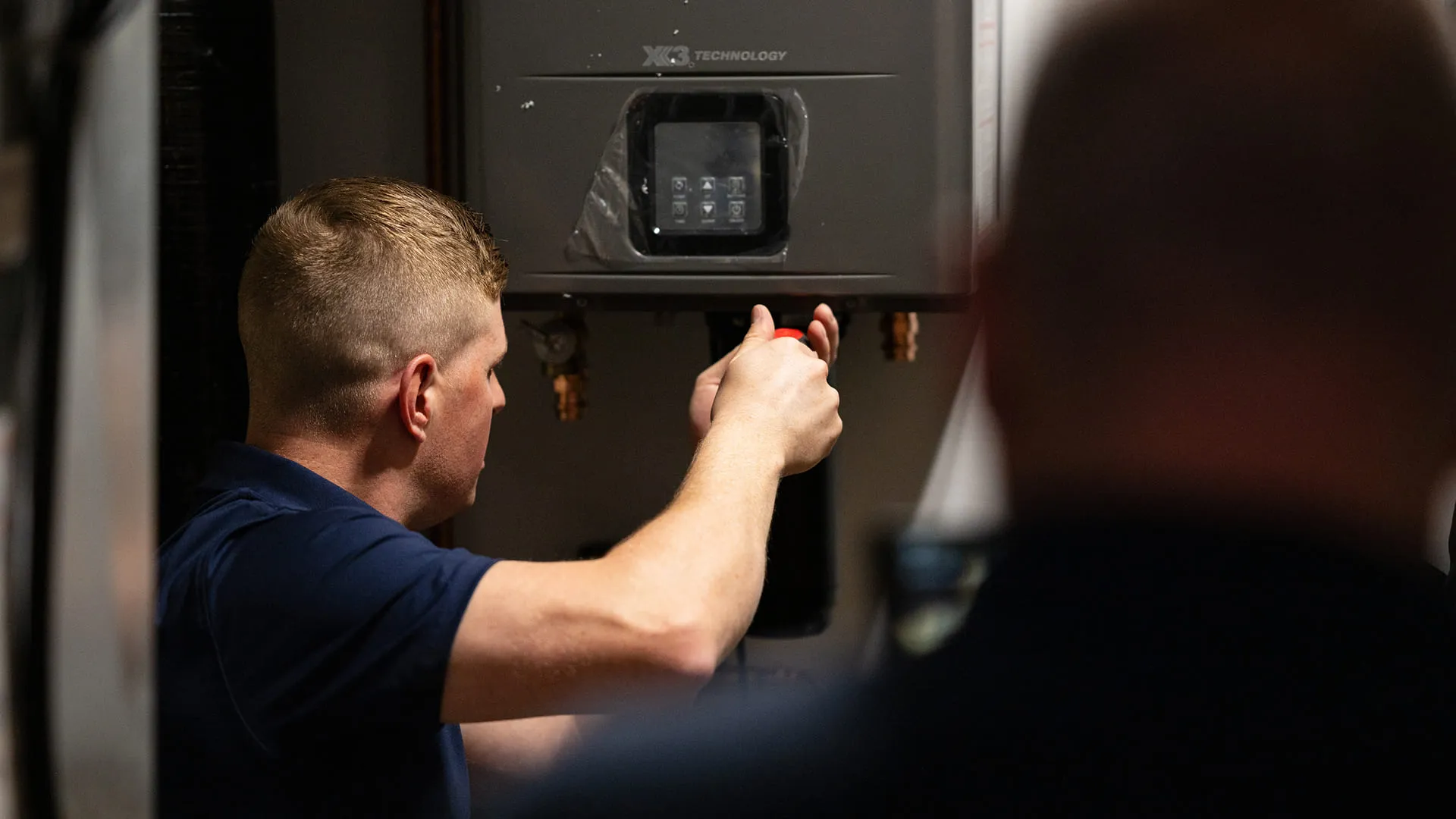 Technician-Installing-Tankless-Water-Heater