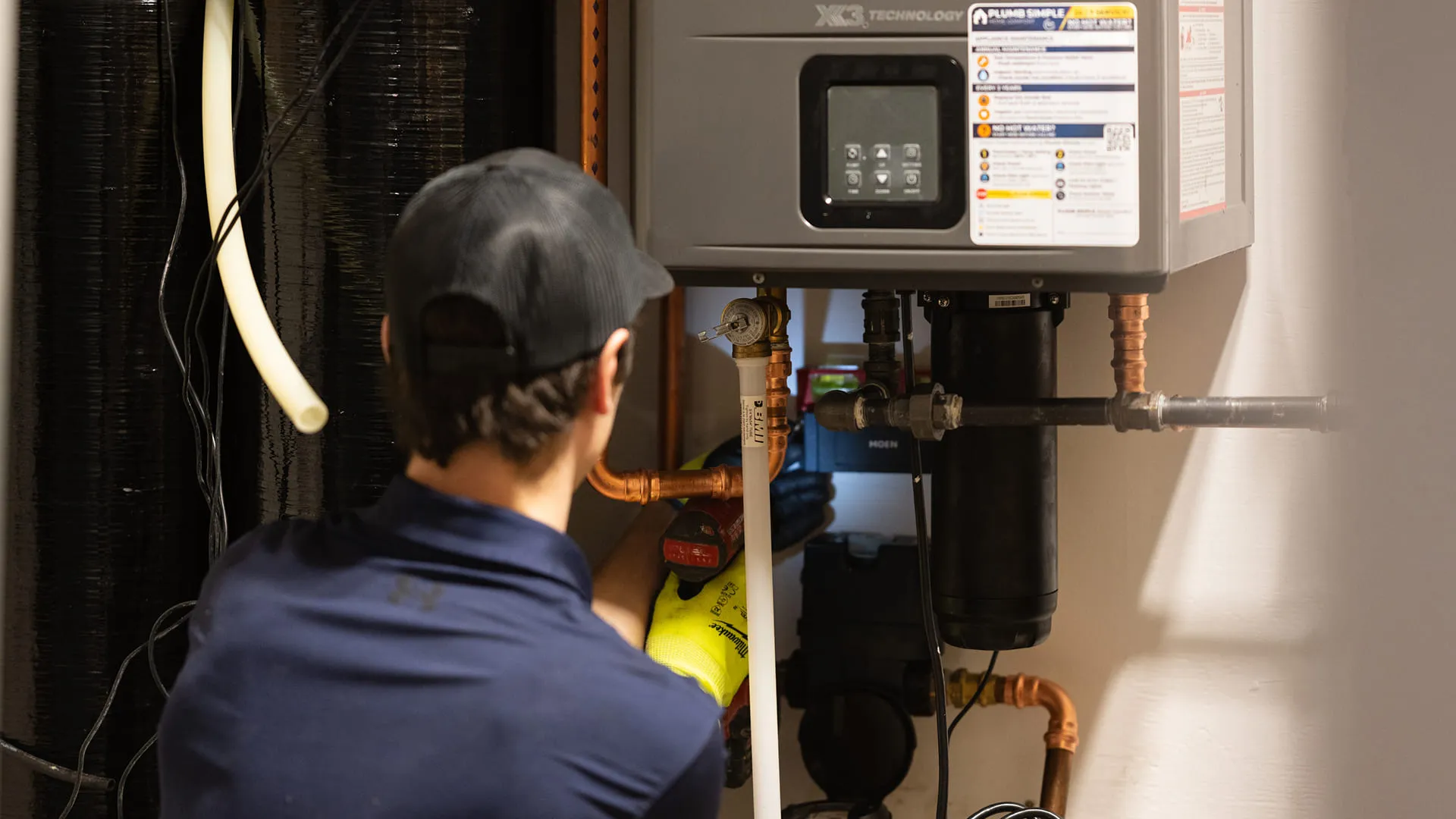 Technician Servicing X3 Tankless Water Heater